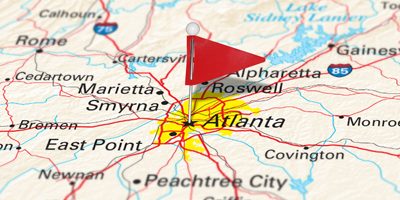 A map pin with a red flag pinpoints Atlanta on a select area from a high quality map.  Map derived from NationalMap.gov