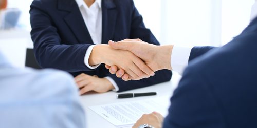 Group of business people or lawyers shaking hands finishing up a meeting , close-up. Success at negotiation and handshake concepts.
